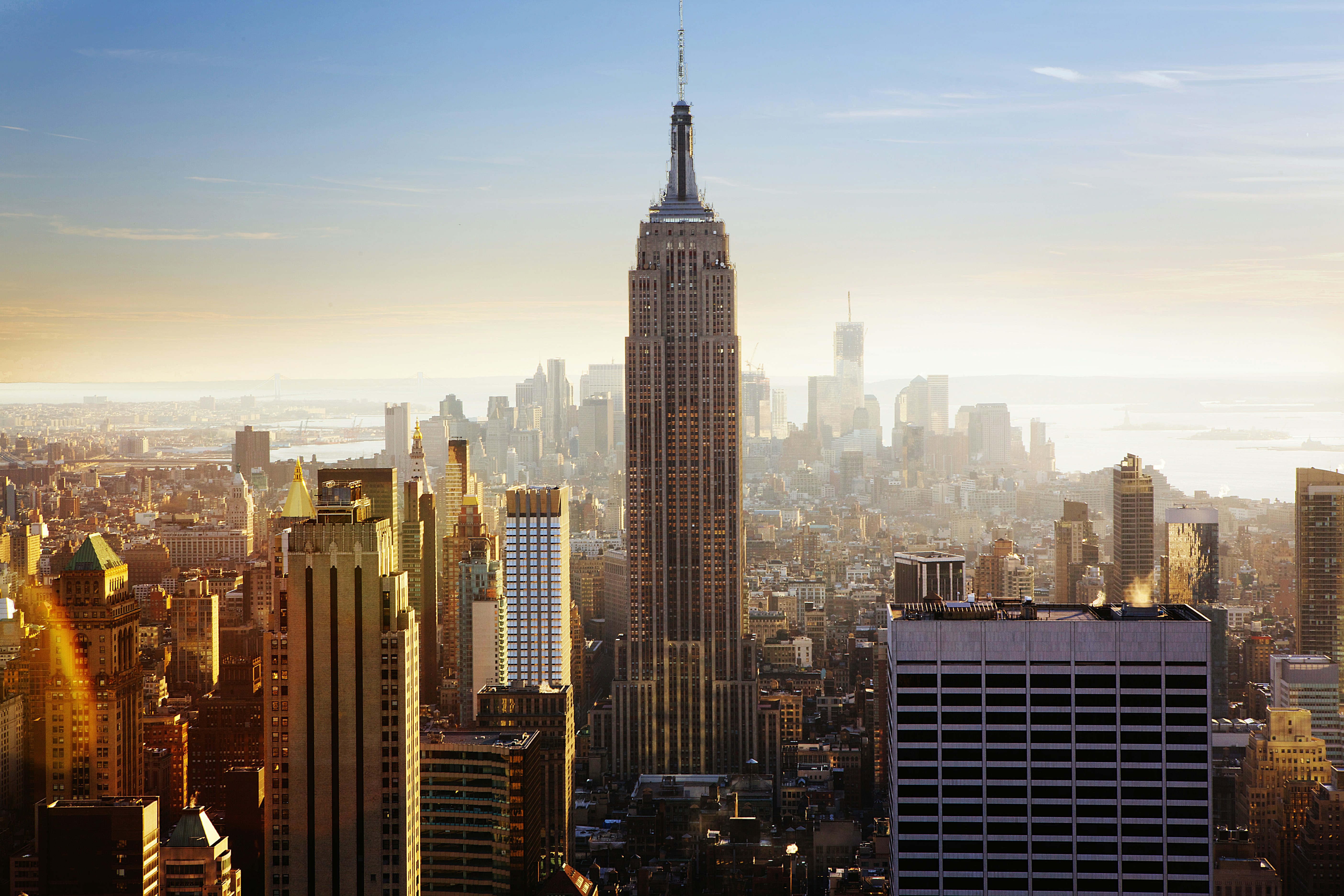 ALT= Debt Collection Agency New York City, NY + picture or sky view of downtown New York City + Empire State Building