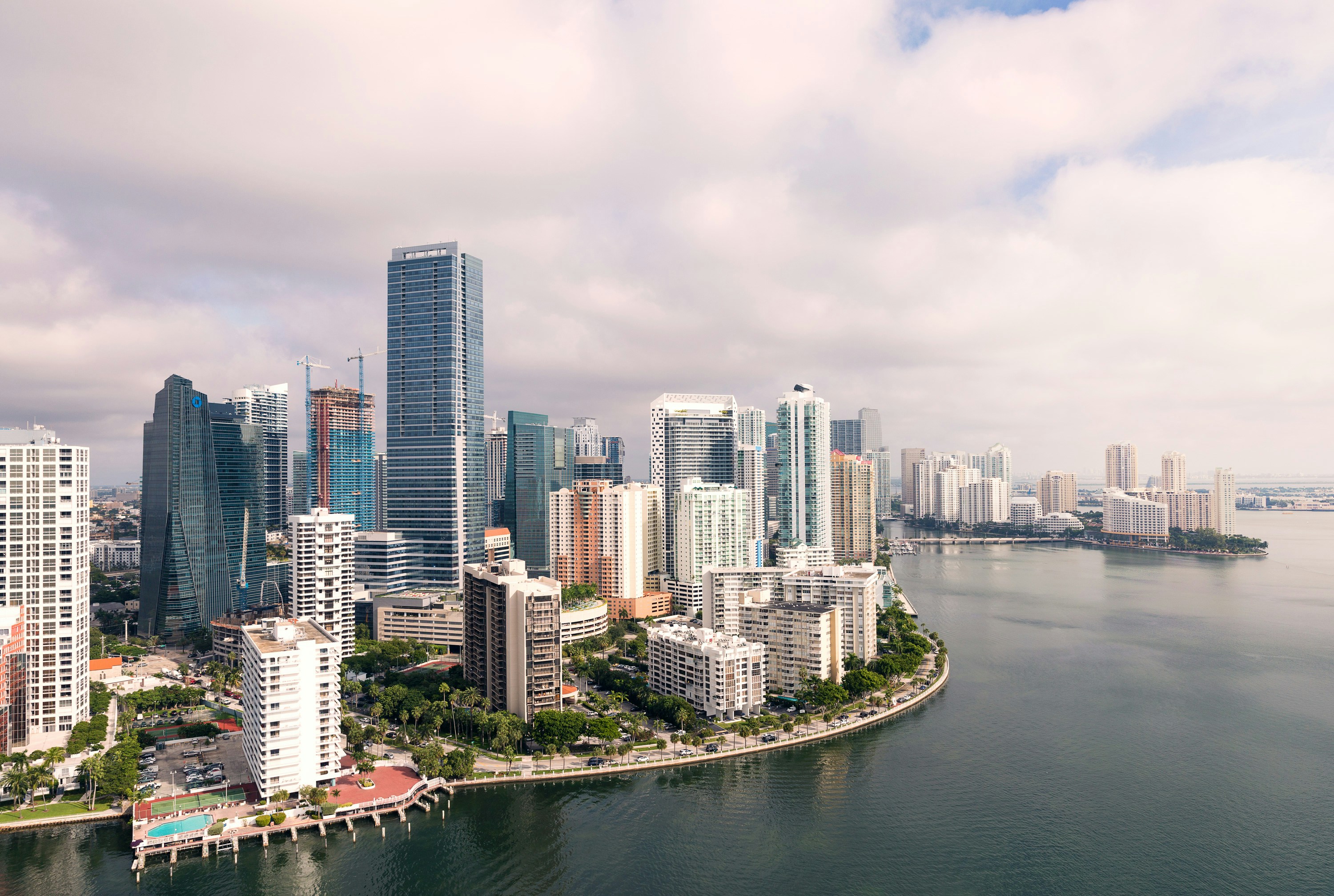 ALT= Debt Collection Agency Miami Florida + picture of downtown Miami + far picture from the water + very cloudy skies +
