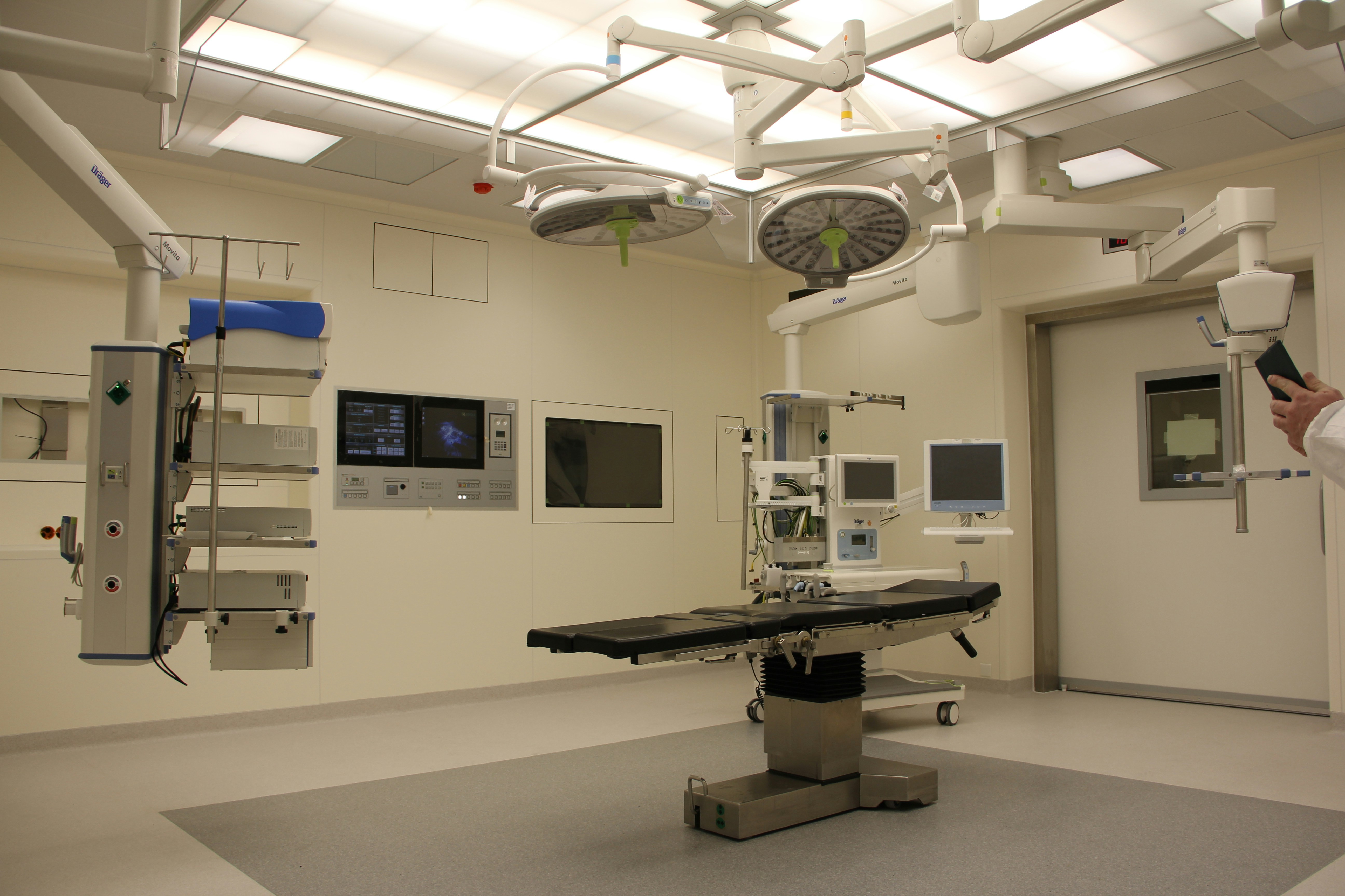 clean white operating room with lots of medical equipment and bright lights for medical industry collections