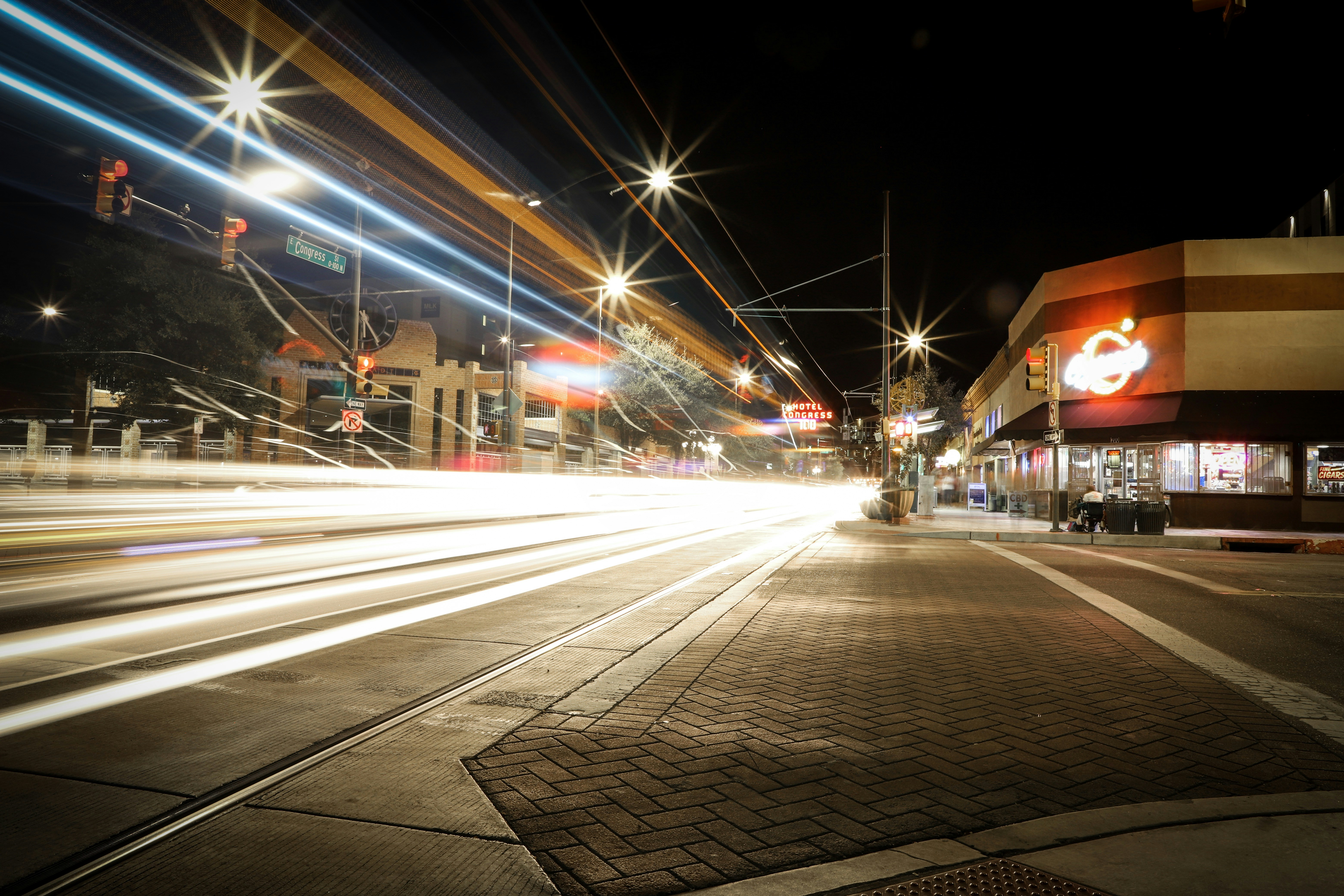 Debt Collection Agencies Tucson Arizona + cars moving fast down the streets of downtown Tucson + at night