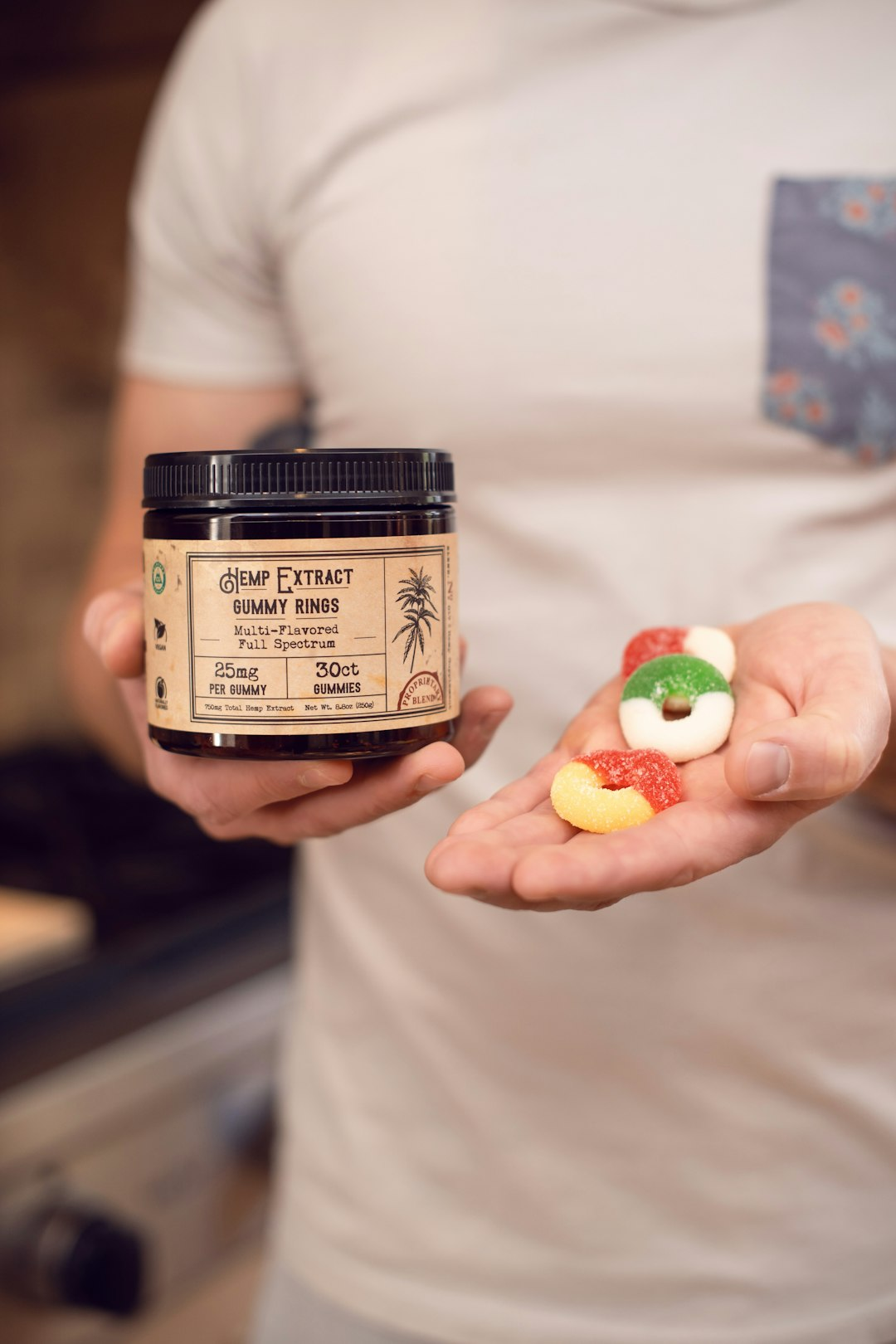 ALT= Debt Collection Agency for the Cannabis Industry + picture + person holding jar and gummies in hand