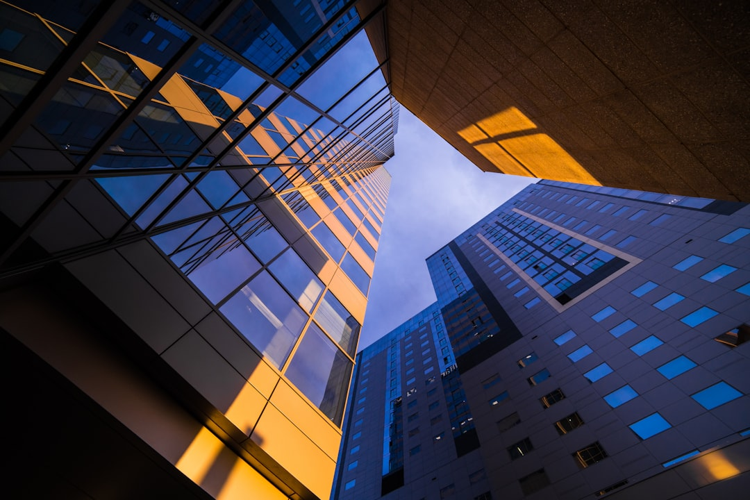 ALT= Debt Collections Agencies Phoenix Arizona + Buildings in Phoenix AZ looking + straight up view + blune + purple + orange color in sky