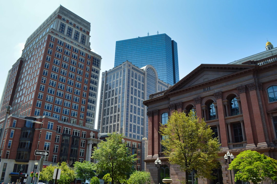 ALT= Debt Collection Agency Springfield MA + picture of downtown Springfield MA + green trees + tall buildings + blue sky