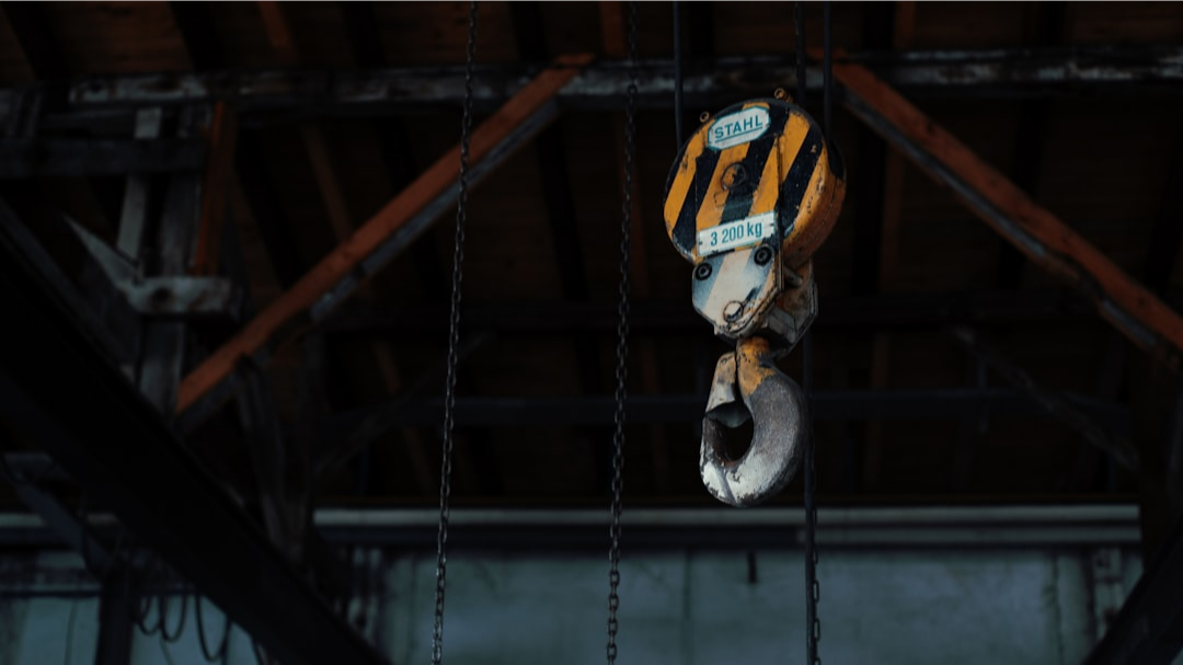 yellow and black hoist in a industrial building